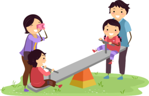 This image shows a boy and girl playing on a see saw while the mother and father watch. The mother is taking a photo of them playing